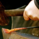Canva - Blacksmith Heating Iron